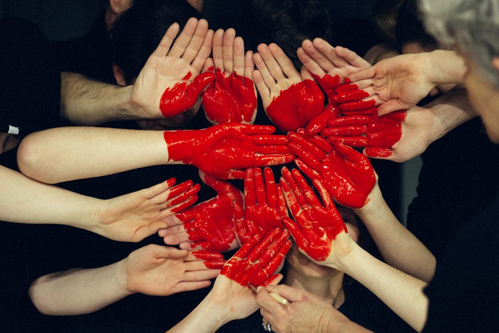 hands with a red heart painted