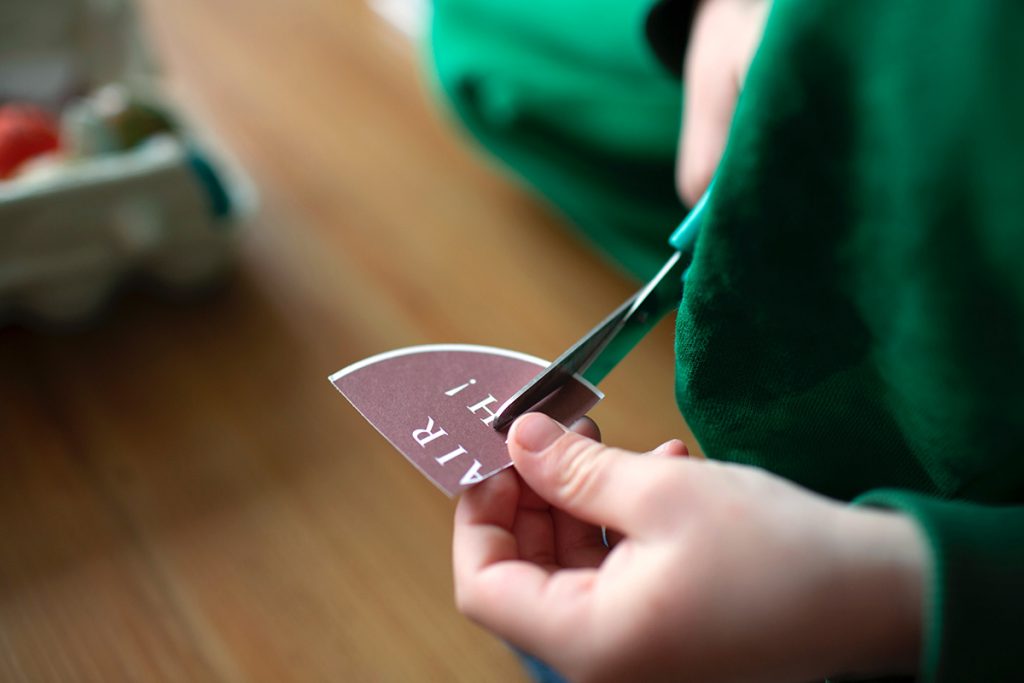 student cutting with scissors