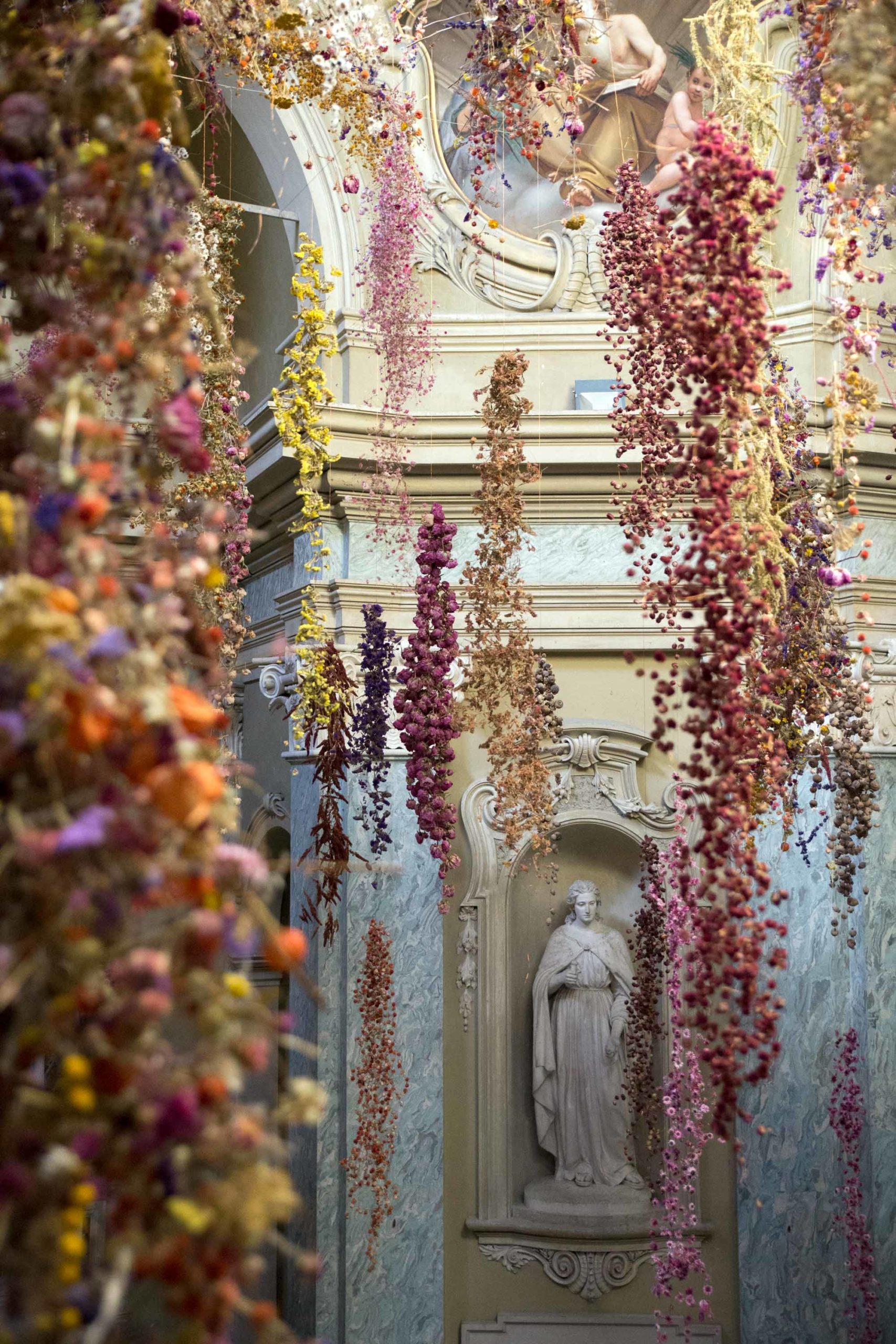 An installation by Rebecca Louise Law made of thousands of fried flowers suspended from the ceiling.