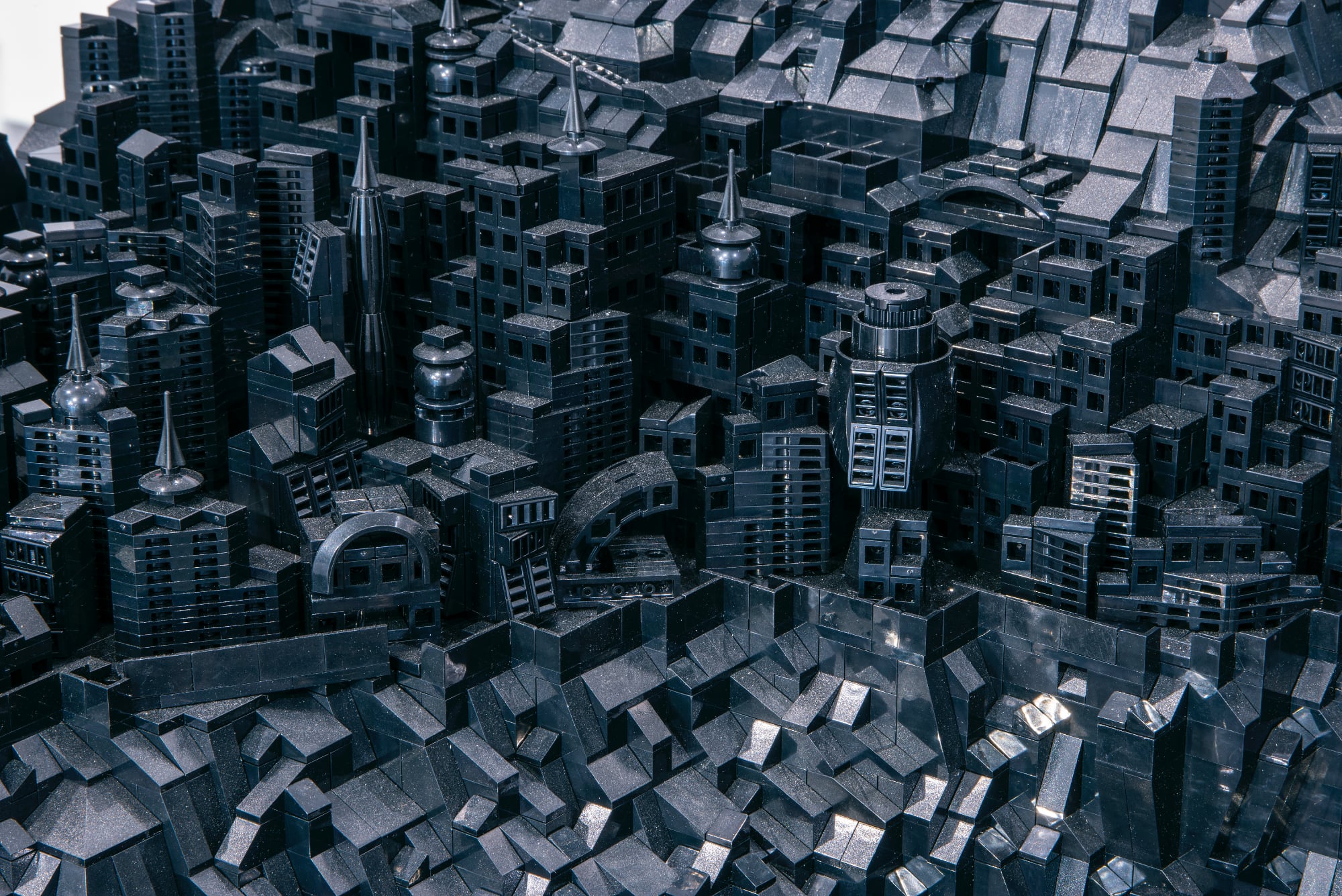 A photo of a detailed cityscape made of black LEGO