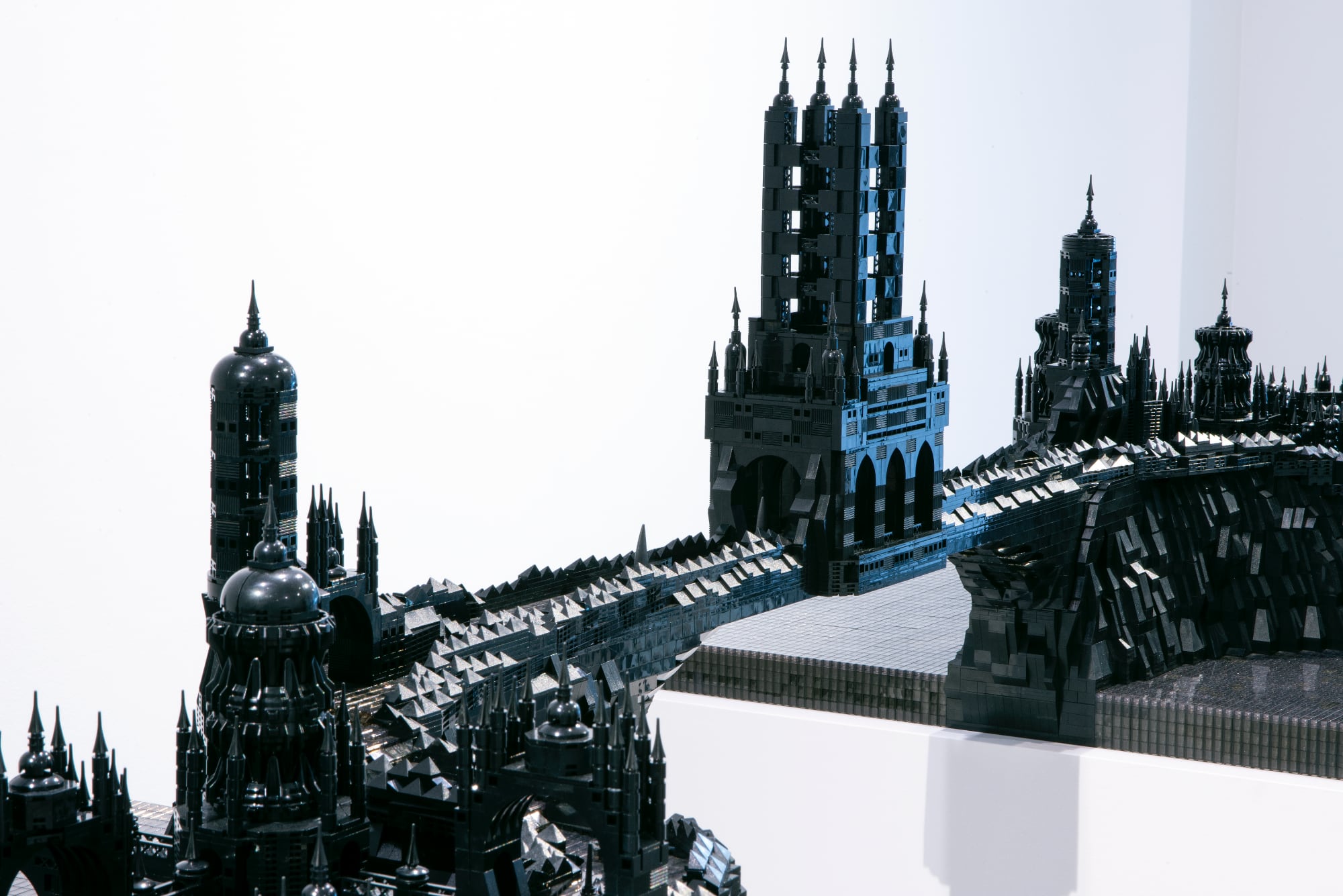 A photo of a detailed cityscape made of black LEGO