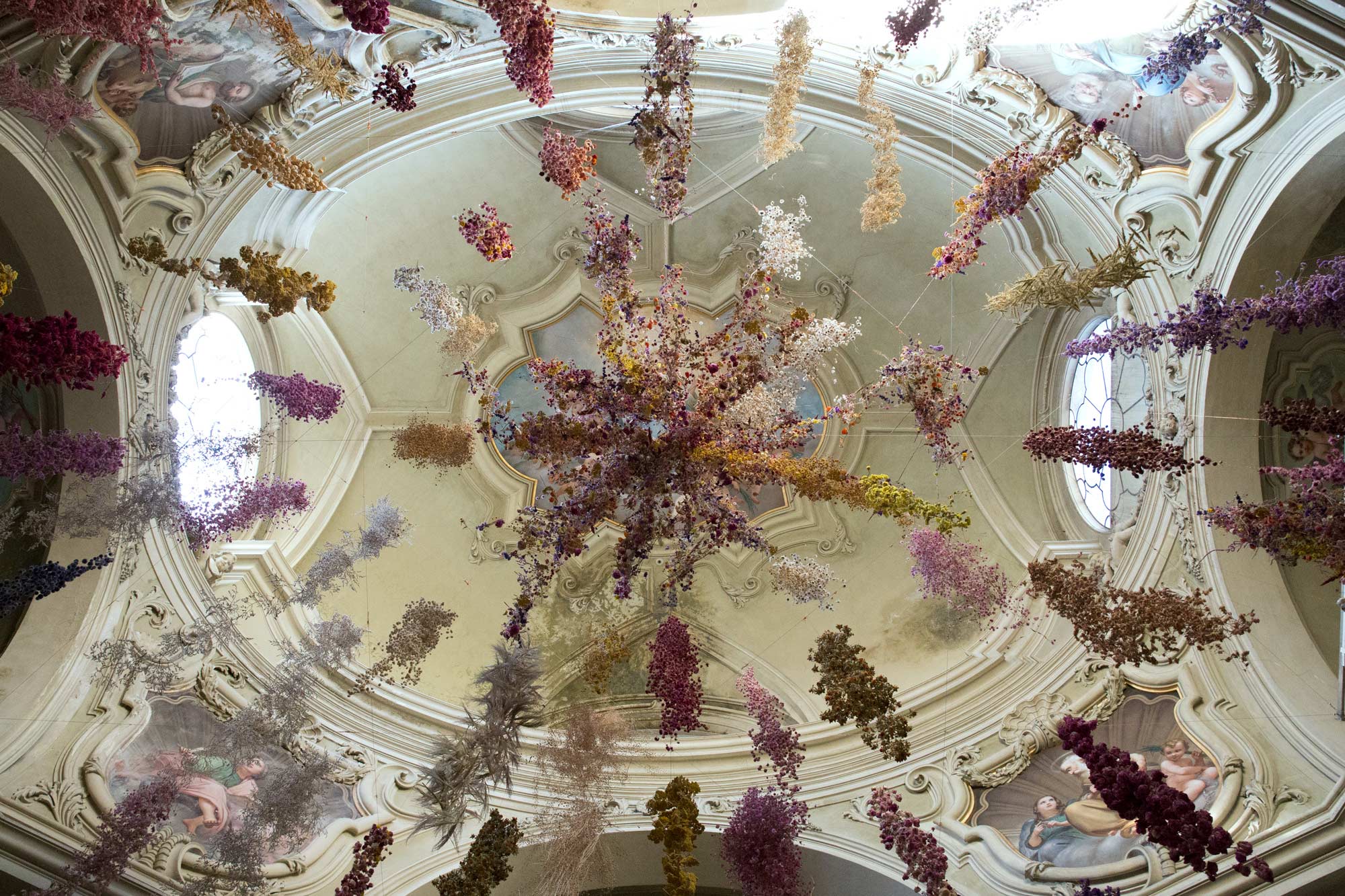 An installation by Rebecca Louise Law made of thousands of fried flowers suspended from the ceiling.