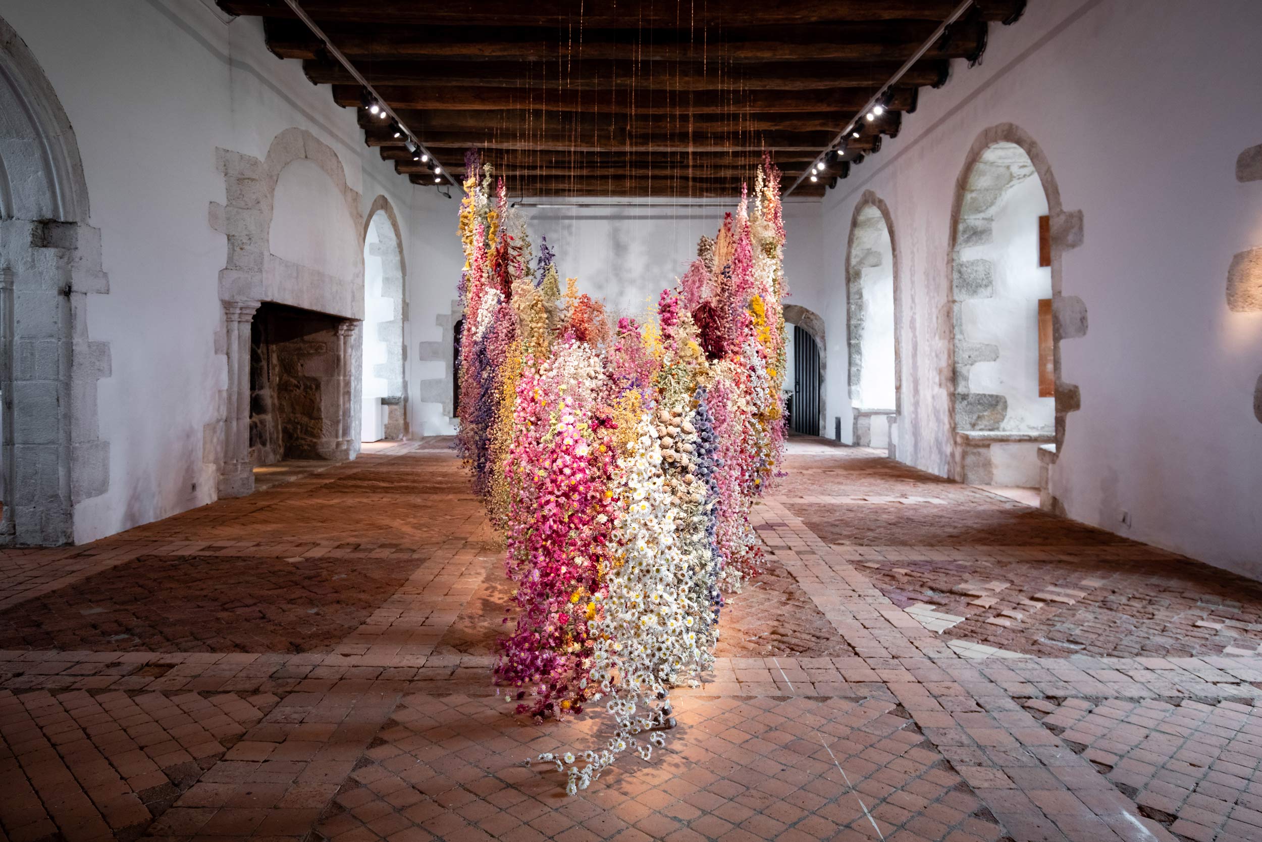 An installation by Rebecca Louise Law made of flowers in the interior of a French château.