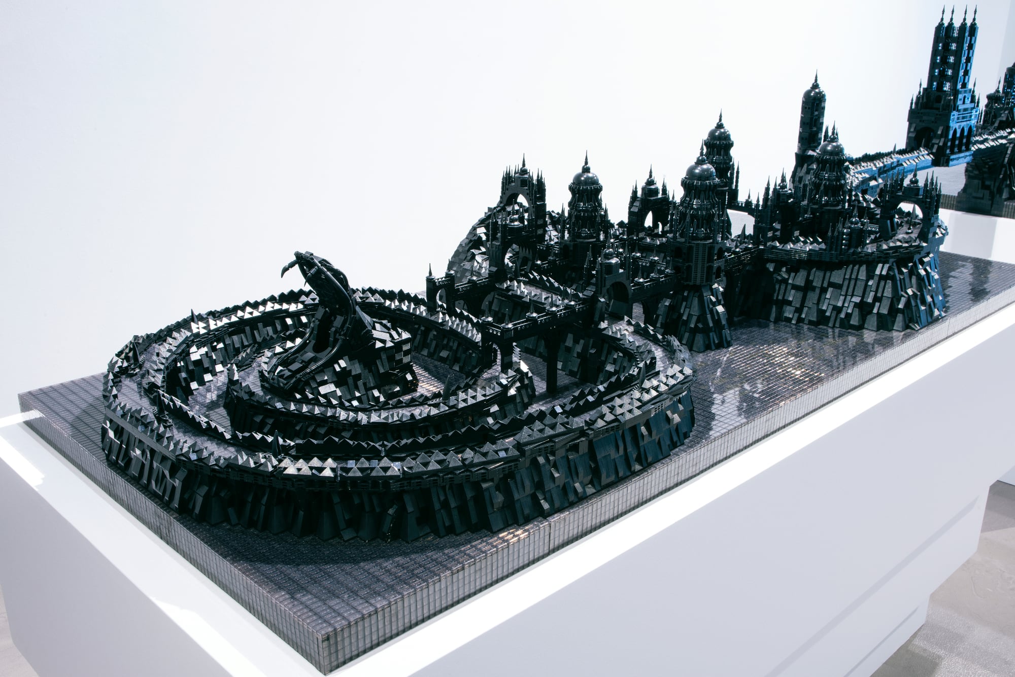 A photo of a detailed cityscape made of black LEGO